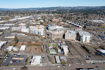 Obraz premium Aerial drone view of City of Beaverton civic complex with Building Department offices and Central MAX light rail station in Oregon USA. Urban infrastructure, rail tracks and rooftop solar panels 