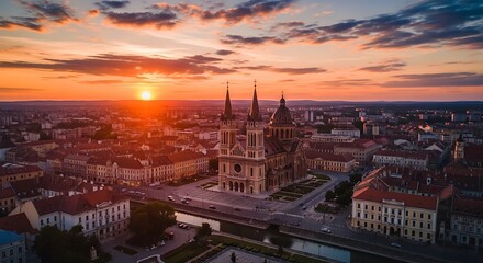 Obraz premium Aerial cityscape at sunset with a large church