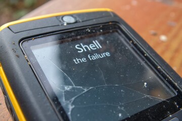 Cracked handheld scanner displaying 'Shell the failure'