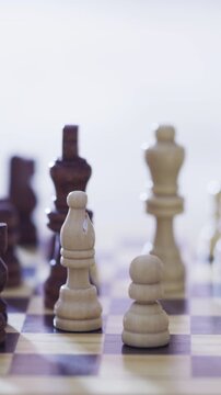 Hands, chess and bishop with board game, piece and problem solving with strategy, play and competition in home. Person, wooden toys and take pawn with contest, challenge and match at apartment