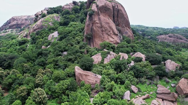 Aerial view of adventurers rock climbing and rappelling on Ramanagara Hill&rsquo;s large rock formation