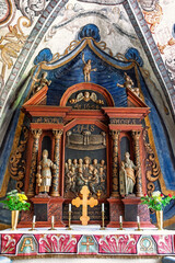 Fototapeta premium Church altar with carved wooden figures and painted vault