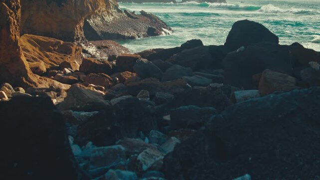 Beautiful nature seascape with azure water and high cliffs on a sunny summer day. Beautiful scenery. Stunning oceanscape featuring azure waters and rocks, blue sky and rolling waves to the shore.