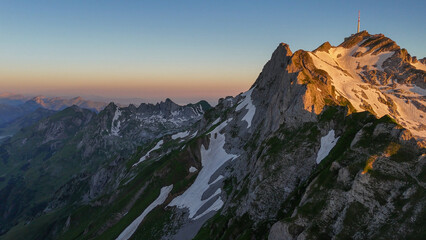 Aerial, bird view, Sunset on S&auml;ntis Alpstein mountain in Switzerland. Amazing sunset, impressive mountains with rocky peaks and slopes. Wonderful nature, alps of Switzerland. Hiking outdoor travel des