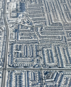 Aerial view snow covered houses in city of Toronto on winter day.