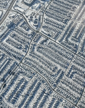 Aerial view snow covered houses in city of Toronto on winter day.