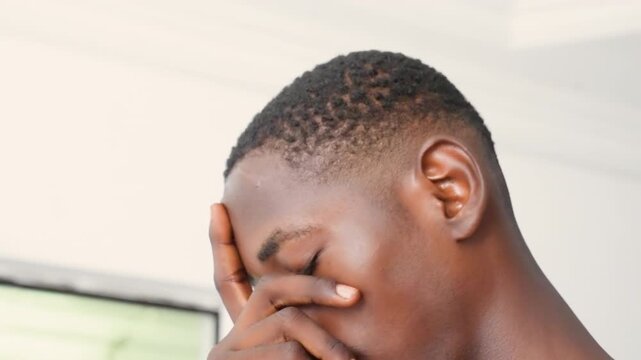 Black male near window pensive gaze, close portrait series showing thoughtful gestures, hand touching face, soft natural light, neutral interior, intimate mood shifts, student and thinker roles
