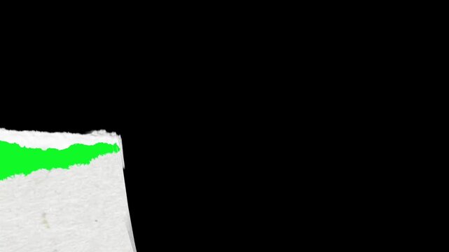 Realistic white paper tearing animation effect revealing a black background over a bright green screen surface for creative video editing projects