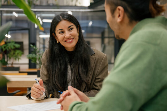 Business meeting discussing new job contract and signing documents at office