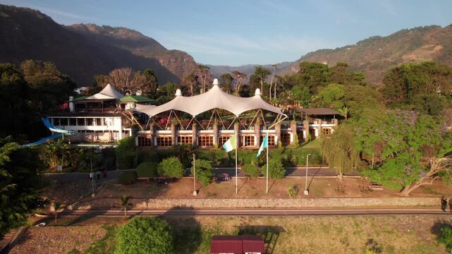 Guatemalan Flag and Town Center at Lake Atitlan, Guatemala, long aerial clip, 4K