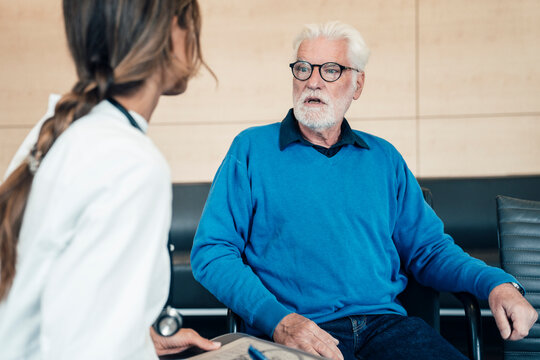 Doctor consulting patient in hospital about digital medicine and healing