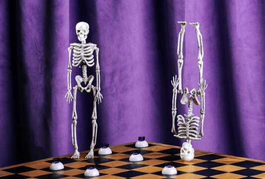 Skeletons on chessboard with eyes and purple theatrical curtain