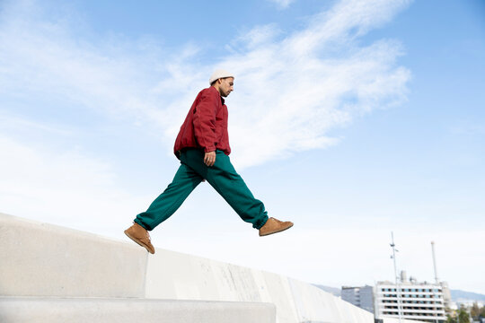 Parkour athlete leaping in urban Barcelona showing agility and courage