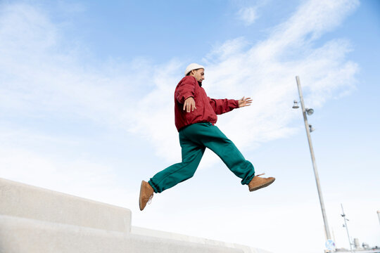 Man jumping mid-air in Barcelona showing agility and urban lifestyle