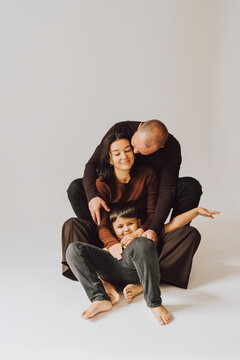 Happy family hugging and cuddling together at home