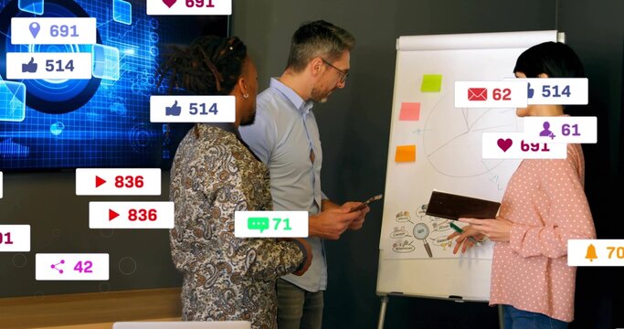 Discussing team pointing at flipchart in meeting room, with pink top, showing social badges display