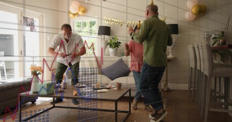 Gathering trio at home wearing patterned, green, peach, placing mugs on table under birthday banner