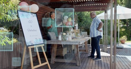Listening senior man standing hands-on-hips on deck under pergola with easel sign 60  and  Fabulous