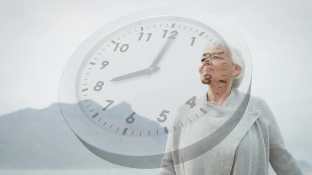 Senior woman standing on shoreline, clock advancing, opening arms and smiling, illustrating health