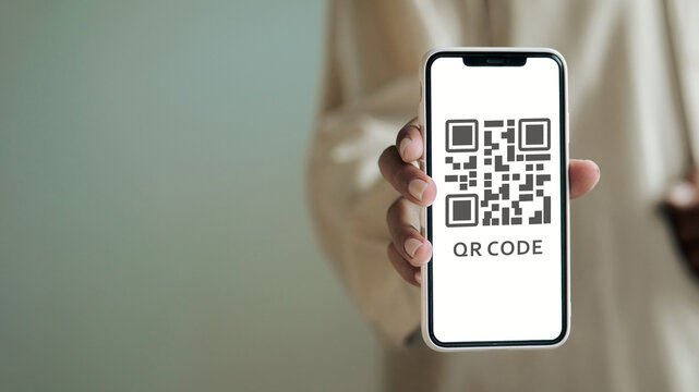 Hand Holding Smartphone with QR Code Screen for Digital Payment and Contactless Technology