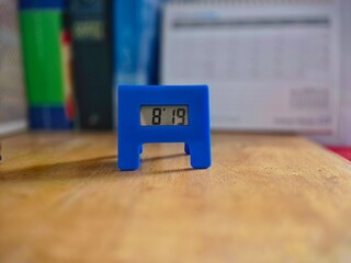 Small Blue Digital Thermometer on Wooden Table Showing 81.9 Degrees