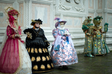 Venice, Italy - February 12, 2026 - People dressed in masks for the Venice Carnival have their...