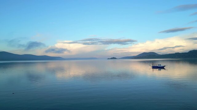 Drone footage captures the stunning natural beauty and historical significance of Bafa Lake Nature Park in Turkey. The aerial perspective showcases the serene waters of Bafa Lake nestled amidst rugged