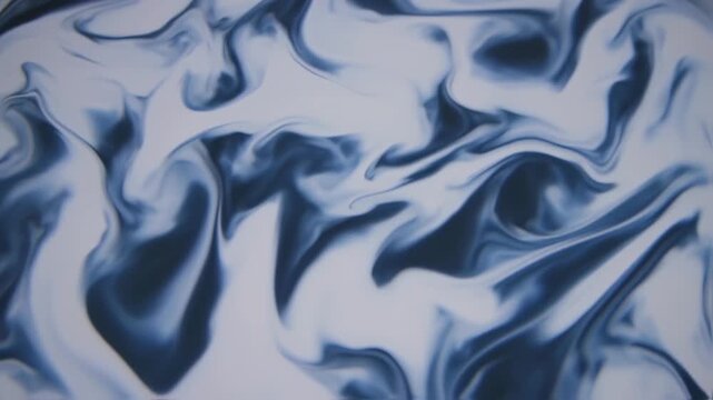 Abstract blue and white wavy liquid surface texture background.