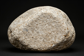 Fototapeta premium Smooth Rounded River Rock with Natural Texture and Earthy Tones Isolated on Black Background for Design or Nature Themed Projects