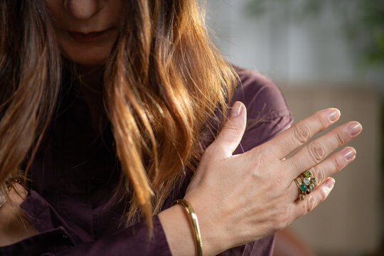 Individual performing EMDR self tapping on shoulders to support bilateral stimulation and emotional regulation. Highlights rhythmic movement and grounding technique.