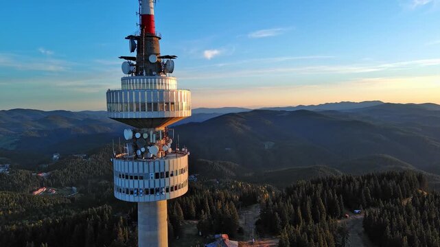 Tower Snezhana on peak of Snezhana covered with spruce forests in Rhodope mountains