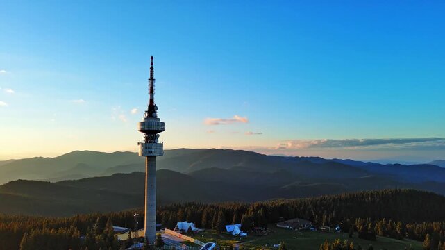 Tower Snezhana on peak of Snezhana covered with spruce forests in Rhodope mountains