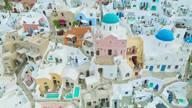 Aerial drone view of Santorini whitewashed buildings and blue domes overlooking caldera cliffs and the Aegean Sea, luxury travel scene, 03 July 2025.