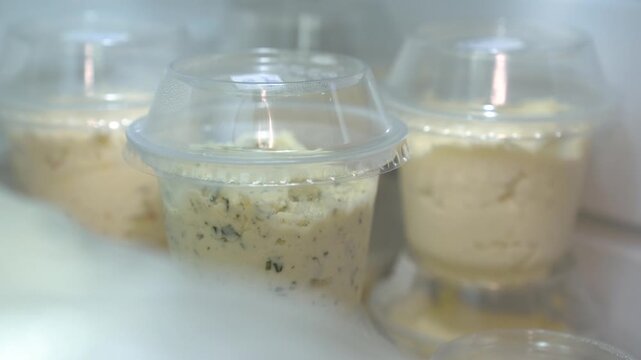 Fresh Jersey cow milk cottage cheese with chives in individual plastic cups