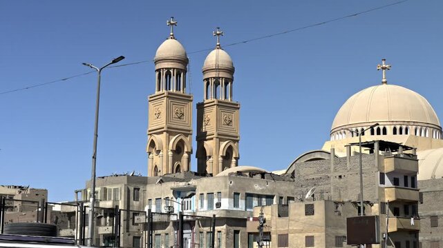 The Coptic Orthodox Cathedral of the Virgin Mary in Luxor, Egypt. The cathedral is a striking example of modern Coptic architecture, characterized by its twin bell towers topped with crosses and a lar