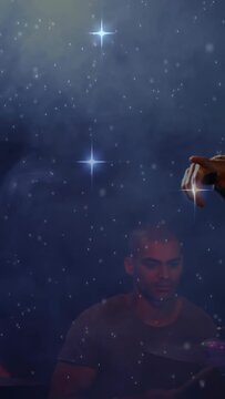 Vertical video: Cam panning, singer singing into mic while drums playing, stars drifting over band