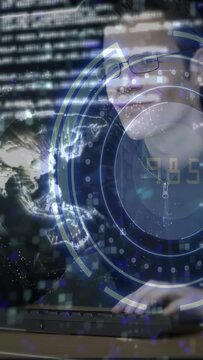 Vertical video: Man with glasses typing keyboard activating HUD globe while analyzing tech data