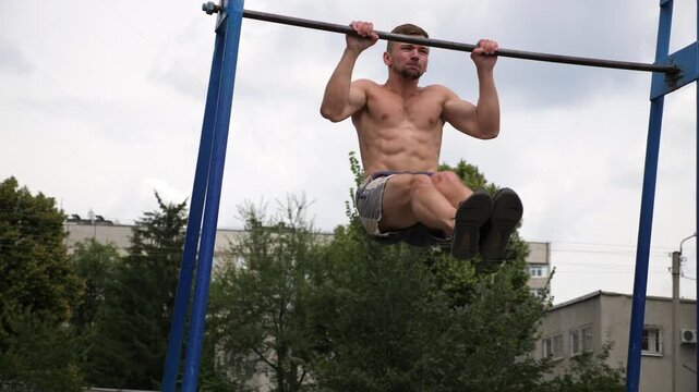 Sportsman performing dynamic workout routine on parallel bars, showcasing strength and control through a series of fluid movements, emphasizing athleticism and dedication to fitness training