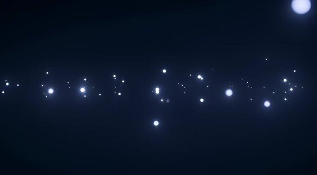 Abstract image of glowing particles floating in a dark indigo space