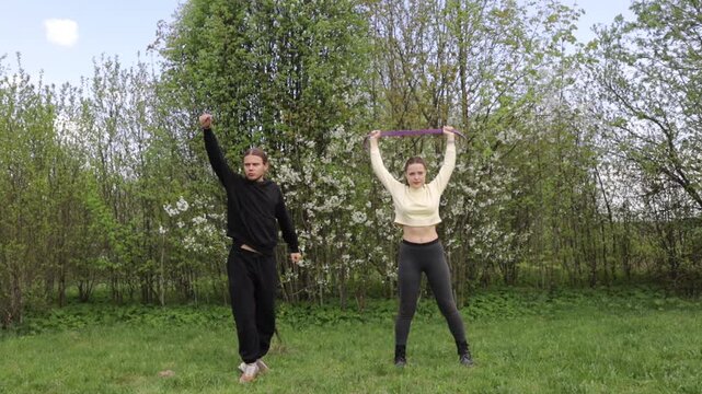 A couple doing a sports warm-up outdoors in the summer