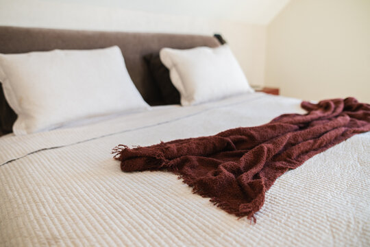 Modern Double Bed with White Linens in a Minimalist Attic Bedroom.