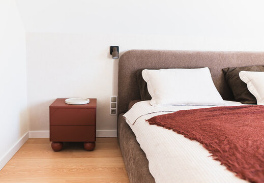 Modern Double Bed with White Linens in a Minimalist Attic Bedroom.