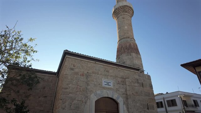 Sehzade Korkut Mosque or Kesik Minaret, seen among the historical houses in the streets of Antalya Old Town