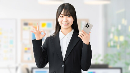 OKサインをする若い女性ビジネスパーソン, Young businesswoman making an OK gesture © Trickster*