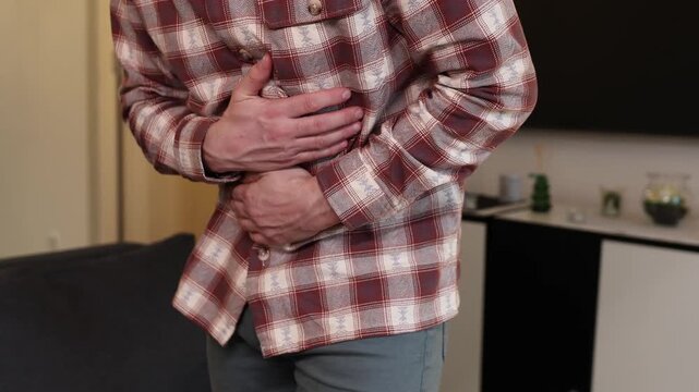 Man with gastritis, chest, stomach and abdominal pain at home.