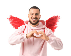 Naklejka premium Young man with Cupid's wings making heart gesture on white background. Valentine's Day celebration