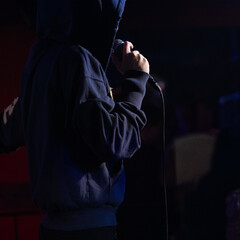 Faceless Rapper Performing with Microphone