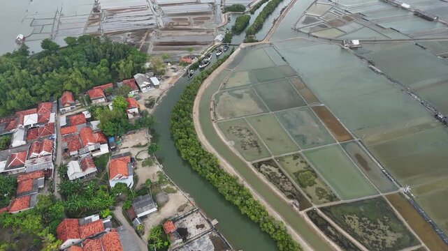 Aerial Top Down View of Coastal Village with Salt Pans and River Canal