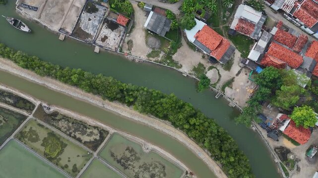 Aerial Top Down View of Coastal Village with Salt Pans and River Canal