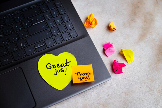 Sticky note with great job message on a laptop 
